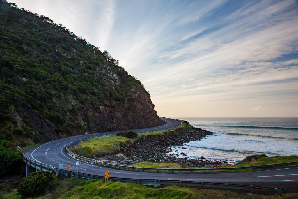 Winding coastal road along cliffs and ocean horizon representing a journey forward